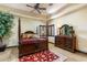 Bedroom with carpet, wood furniture, and a dark wood four poster bed at 10537 N Crestview Dr, Fountain Hills, AZ 85268