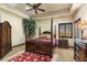 Bedroom with a dark wood four poster bed and windows with dark wood shutters at 10537 N Crestview Dr, Fountain Hills, AZ 85268