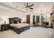 This main bedroom features an elegant chandelier, a ceiling fan, and a seating area with great natural light at 10537 N Crestview Dr, Fountain Hills, AZ 85268