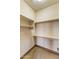 A walk-in closet with carpeted floor and wooden shelves. Ready for storage! at 10537 N Crestview Dr, Fountain Hills, AZ 85268