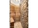This wine cellar features stone walls, tile floor, and custom wood wine racks at 10537 N Crestview Dr, Fountain Hills, AZ 85268
