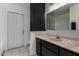 Bathroom featuring a single sink vanity with tan stone countertop and black cabinets for storage at 4729 W Orangewood Ave, Glendale, AZ 85301