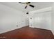 This bedroom features wood-look floors, a closet, and a ceiling fan at 4729 W Orangewood Ave, Glendale, AZ 85301