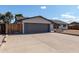 View of the garage and side gate, highlighting the driveway and exterior features at 4729 W Orangewood Ave, Glendale, AZ 85301