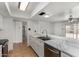 Bright kitchen featuring white cabinets, marble countertops, and a stainless steel sink at 4729 W Orangewood Ave, Glendale, AZ 85301