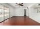 Bright living room with hardwood floors, sliding glass doors, and a view to the kitchen at 4729 W Orangewood Ave, Glendale, AZ 85301