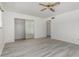 Spacious main bedroom with wood-look floors, closet, and access to the rest of the home at 4729 W Orangewood Ave, Glendale, AZ 85301