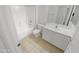 Well-lit bathroom featuring a shower-tub combination, tile floors, and a vanity with storage at 16186 W Silver Falls Dr, Surprise, AZ 85374