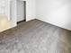 Clean and simple bedroom with neutral carpet and access to a spacious closet at 16186 W Silver Falls Dr, Surprise, AZ 85374