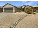 Charming single-story home featuring low-maintenance desert landscaping and a neutral color palette at 16186 W Silver Falls Dr, Surprise, AZ 85374
