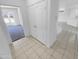 Hallway showing the tile floors and a bedroom with carpet flooring at 16186 W Silver Falls Dr, Surprise, AZ 85374