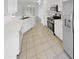 Bright kitchen featuring white cabinetry, stainless steel appliances, and tile flooring at 16186 W Silver Falls Dr, Surprise, AZ 85374