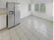 Bright kitchen featuring stainless steel refrigerator and tile flooring at 16186 W Silver Falls Dr, Surprise, AZ 85374