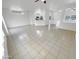 Spacious living room with tile flooring, all-white walls, and views into other rooms at 16186 W Silver Falls Dr, Surprise, AZ 85374