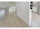 Open concept living area featuring light tile floors and views into the kitchen at 16186 W Silver Falls Dr, Surprise, AZ 85374