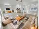 Bright living room featuring tile flooring, plush seating, and a view of the adjacent kitchen at 16186 W Silver Falls Dr, Surprise, AZ 85374