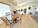 Cozy dining area open to kitchen, featuring a wooden table and comfortable seating at 10826 W Piute Ave, Sun City, AZ 85373