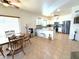 Open-concept dining area with access to modern kitchen and stainless steel appliances at 10826 W Piute Ave, Sun City, AZ 85373