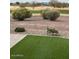 Beautiful backyard featuring lush green grass and desert landscaping at 4198 N Spyglass Dr, Florence, AZ 85132