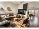 Bright living room with hardwood floors, comfortable seating, and a large-screen television at 11322 W Diana Ave, Peoria, AZ 85345