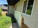 Image of damaged exterior wall near window, with vegetation nearby at 1535 E Christy Dr, Phoenix, AZ 85020