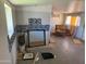 Interior shot of a living room with gray tile floors, a mirror and some debris at 1535 E Christy Dr, Phoenix, AZ 85020
