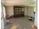 View of a living room with tile floors and an ornate hutch with decorations inside at 1535 E Christy Dr, Phoenix, AZ 85020