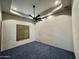 A bright room with a ceiling fan and a window with brown shutters, offering cozy ambiance at 4327 E Capricorn Pl, Chandler, AZ 85249