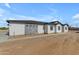 Single story home featuring stone accents, black trim, and an expansive yard at 26615 S 181St Pl, Queen Creek, AZ 85142