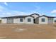 Single story home featuring stone accents, black trim, and a low maintenance landscape at 26615 S 181St Pl, Queen Creek, AZ 85142