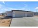 Two car garage with concrete driveway and exterior lighting at 26615 S 181St Pl, Queen Creek, AZ 85142