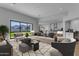 Bright, open-concept living room featuring neutral tones, stylish furniture, and seamless flow to the kitchen at 26615 S 181St Pl, Queen Creek, AZ 85142