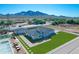 Aerial view of a house featuring a pool, basketball court, desert landscaping, and mountain views at 26761 S 181St Pl, Queen Creek, AZ 85142