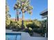Tranquil backyard featuring a glistening pool, vibrant landscaping, and chic patio design at 8517 N 48Th Pl, Paradise Valley, AZ 85253