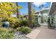 Elegant front yard with lush landscaping, leading to a modern home with floor-to-ceiling glass windows at 8517 N 48Th Pl, Paradise Valley, AZ 85253