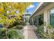 Stunning walkway surrounded by lush plants and landscaping leading to a modern home entrance with glass windows at 8517 N 48Th Pl, Paradise Valley, AZ 85253