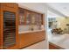 Built-in cabinets with glass doors for display in this kitchen with views to the living room at 8517 N 48Th Pl, Paradise Valley, AZ 85253