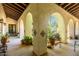 Covered walkway with arched entryways and potted plants at 31221 N 161St Pl, Scottsdale, AZ 85262