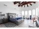 Main bedroom with high ceilings, wood beams, and exercise equipment at 31221 N 161St Pl, Scottsdale, AZ 85262