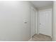 Simple hallway with two doors and neutral colored walls at 16013 S Desert Foothills Pkwy # 1136, Phoenix, AZ 85048