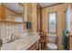 Charming bathroom featuring patterned wallpaper, wooden fixtures, and a shower for a comfortable experience at 17200 W Bell Rd # 624, Surprise, AZ 85374