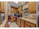 Bright kitchen with wood cabinets, white tile floors, and natural light, offering a welcoming cooking space at 17200 W Bell Rd # 624, Surprise, AZ 85374