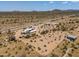 Aerial view of a desert property featuring a house and expansive land at 192 S Ralston Rd, Maricopa, AZ 85139