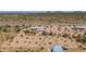Aerial view of a desert home with surrounding land and distant mountains at 192 S Ralston Rd, Maricopa, AZ 85139