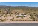 Aerial view showing a house on a large desert lot with mountain views at 192 S Ralston Rd, Maricopa, AZ 85139