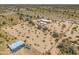 Aerial view of a desert property with a house and detached workshop at 192 S Ralston Rd, Maricopa, AZ 85139