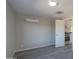 Spacious bedroom with wall-mounted AC unit and wood-look flooring at 192 S Ralston Rd, Maricopa, AZ 85139