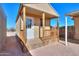 Small house exterior with wooden porch and railing at 192 S Ralston Rd, Maricopa, AZ 85139