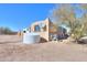 Side view of the house with a water tank and satellite dish at 192 S Ralston Rd, Maricopa, AZ 85139