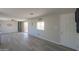 Living room with gray vinyl flooring and sliding glass door at 192 S Ralston Rd, Maricopa, AZ 85139